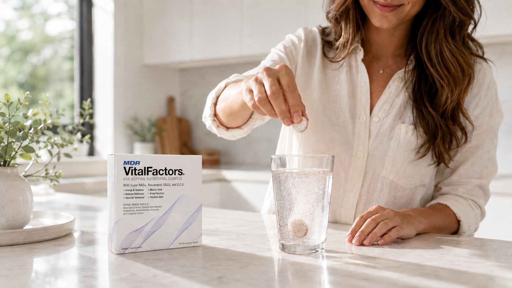 A woman dropping a VitalFactors effervescent tablet into a glass of water on a sunlit kitchen counter, next to the VitalFactors box.
